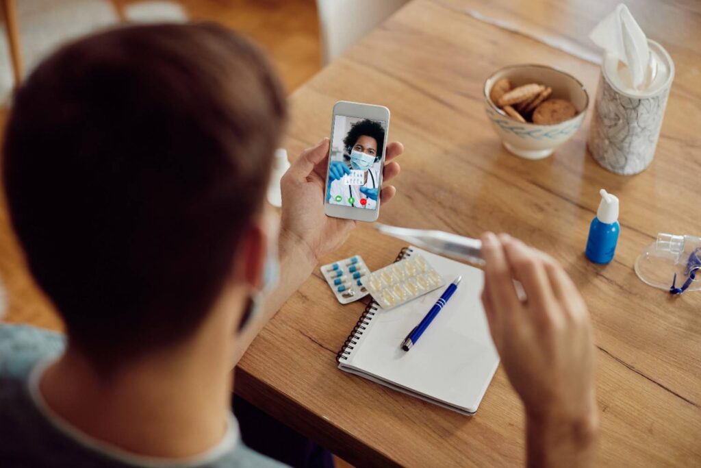 Patient speaking to a UK clinician during a same-day online medical consultation from home.