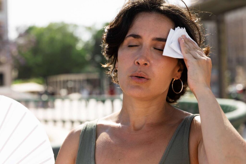Person in the UK heatwave looking fatigued while taking sertraline medication