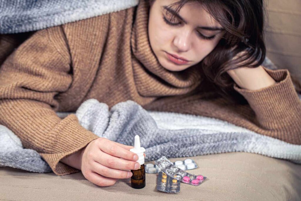 Close-up of sertraline medication tablets beside a glass of water during hot weather in the UK